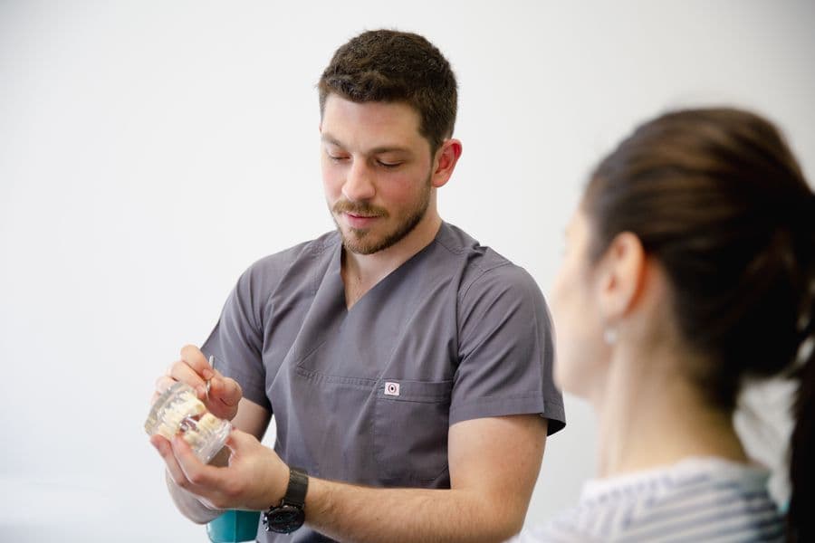 A dentist explaining treatment options to a patient