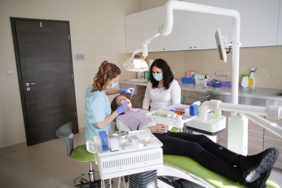 Dental professionals caring for a patient in a modern clinic