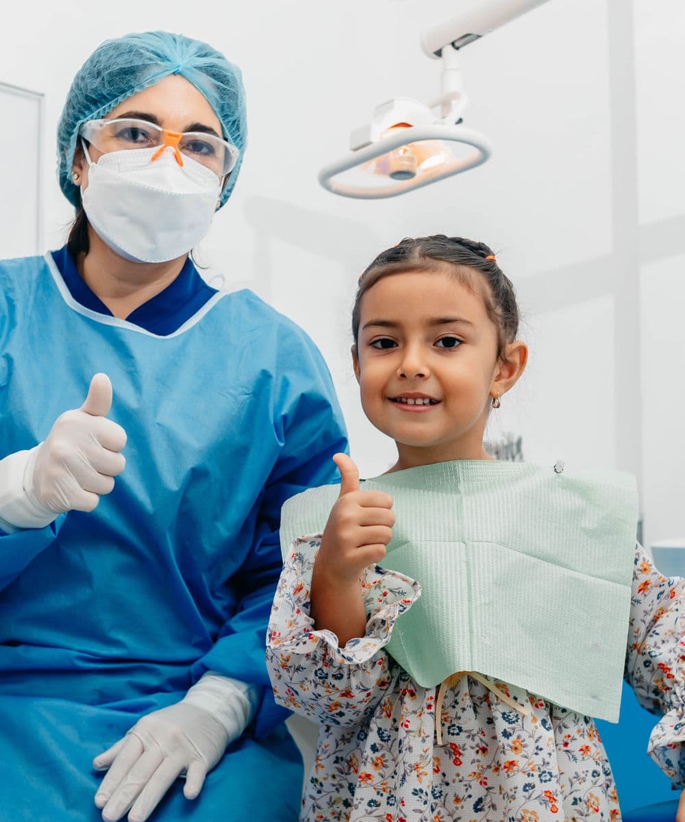 A Rivergum Dental clinician with a happy young patient